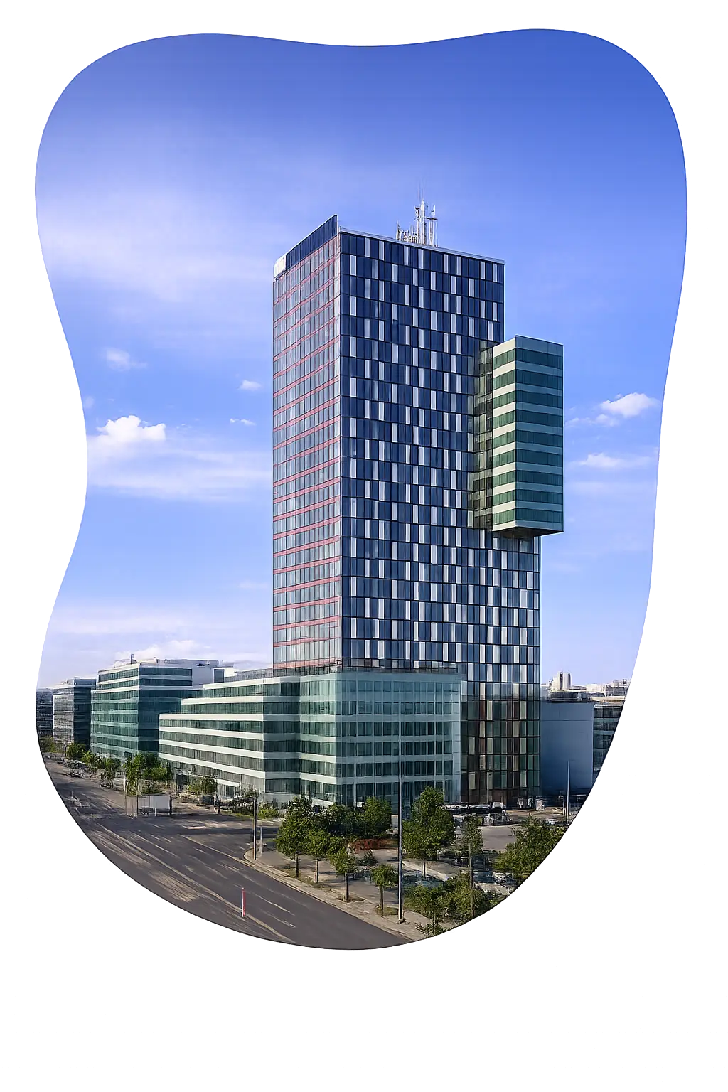Modern high-rise office building with glass facade under a blue sky